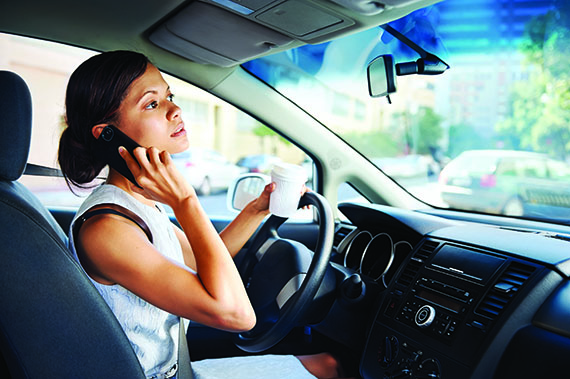 Distracted Driver on the phone and drinking coffee